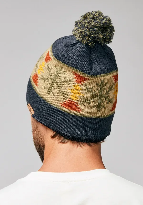 Back view of a navy pom-pom beanie with a multicolour knitted pattern