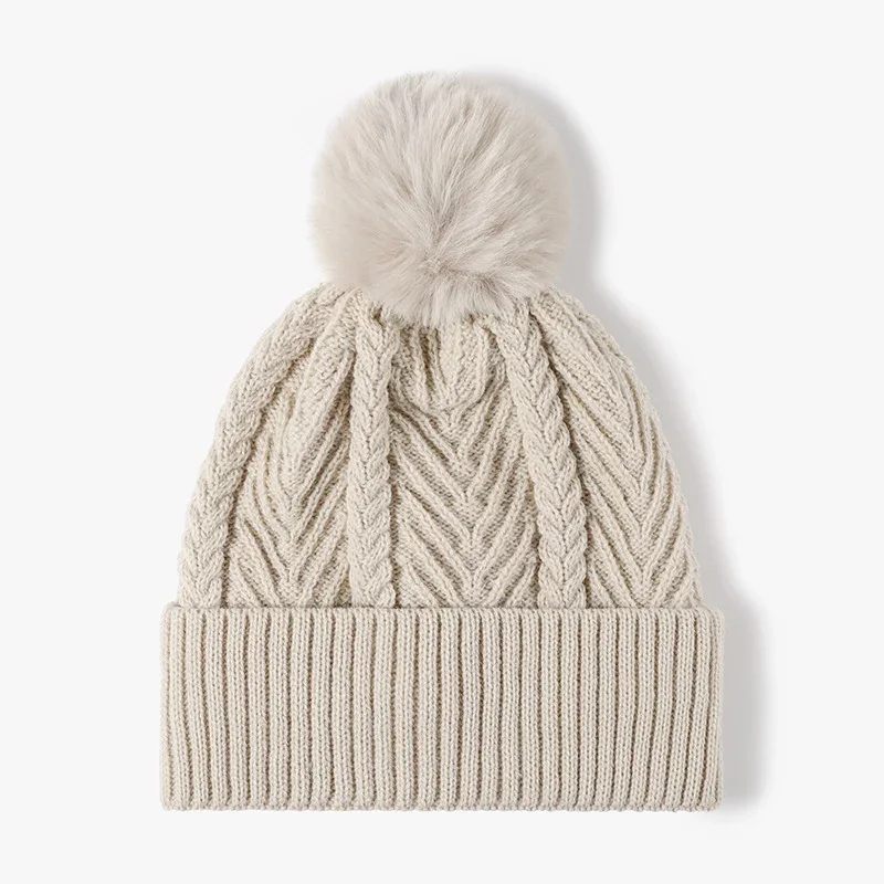 Beige textured cable knit winter beanie with a pom-pom