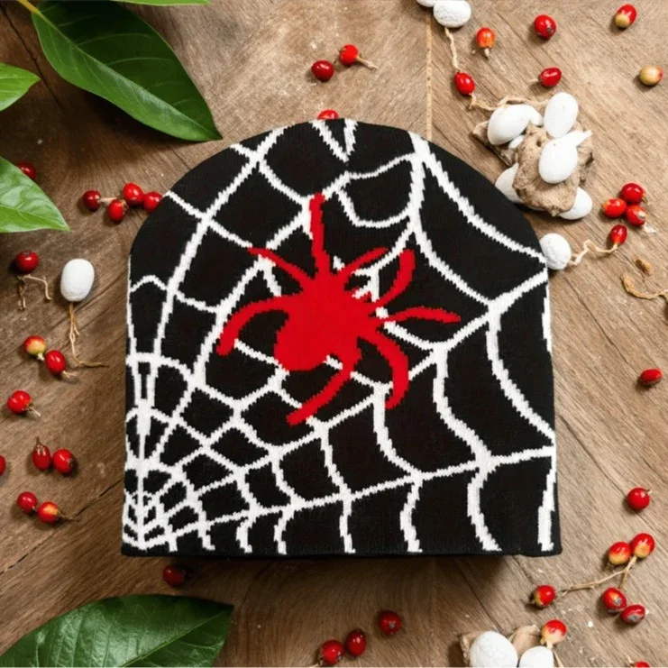 Black knit beanie with a white web and red spider motif