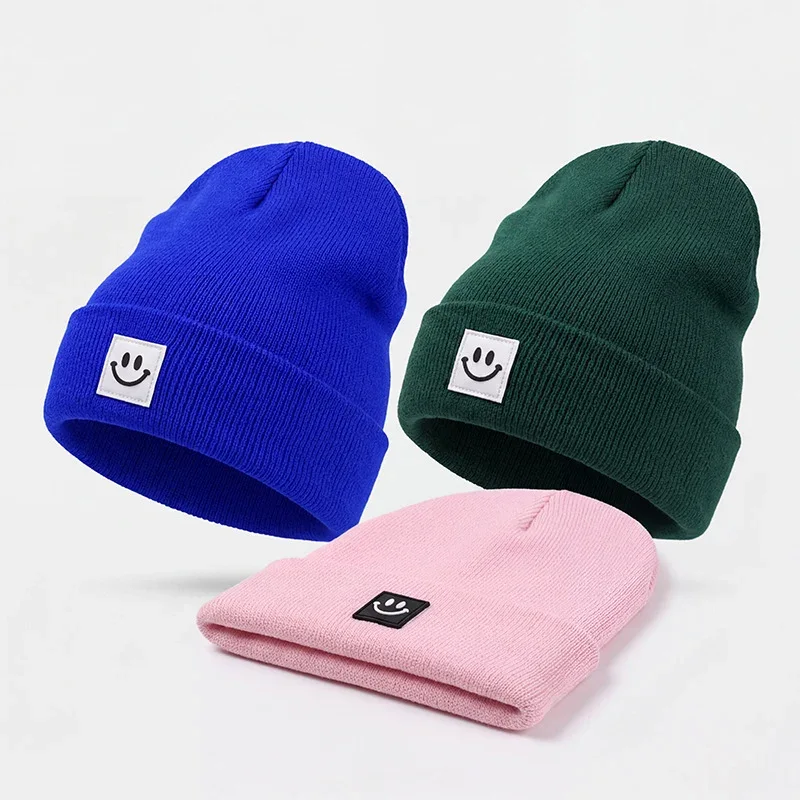 Blue green and pink cuffed knit beanies with square labels