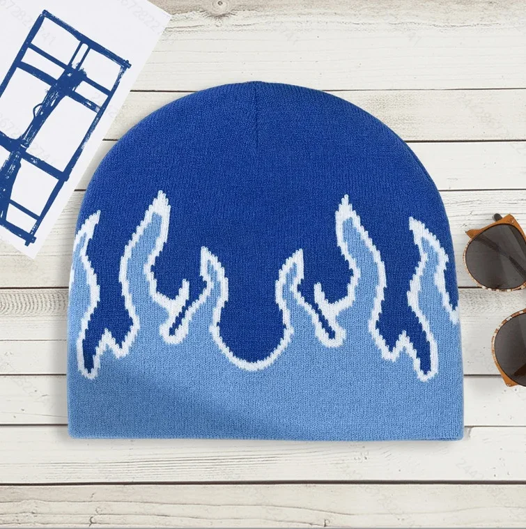 Blue knitted beanie with a lighter blue and white flame-inspired pattern.