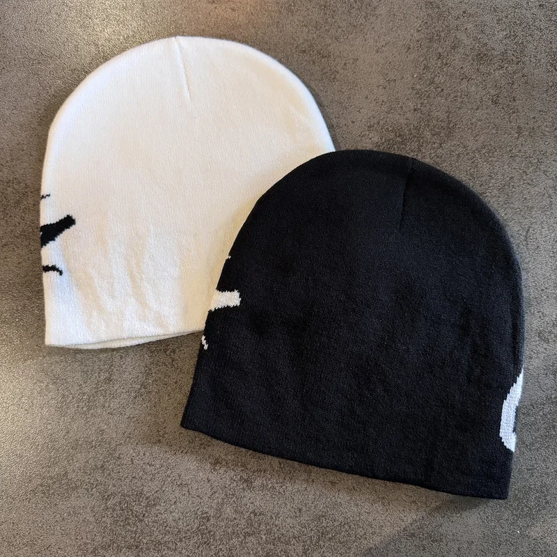 Cream and black knit beanies showing plain sides
