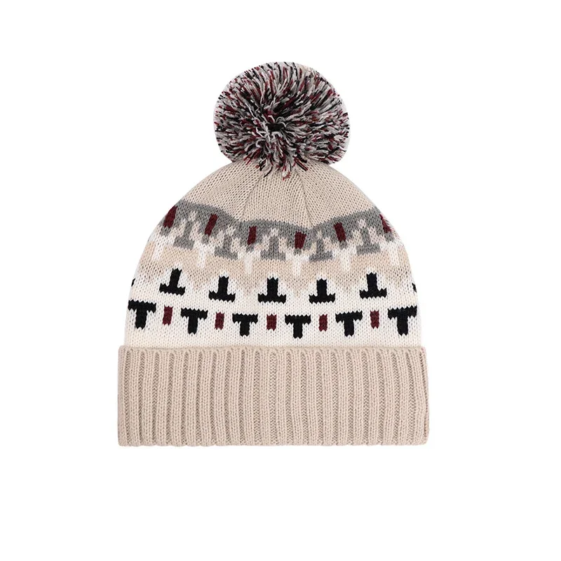 Cream pom pom beanie with contrasting geometric knit bands and a ribbed cuff