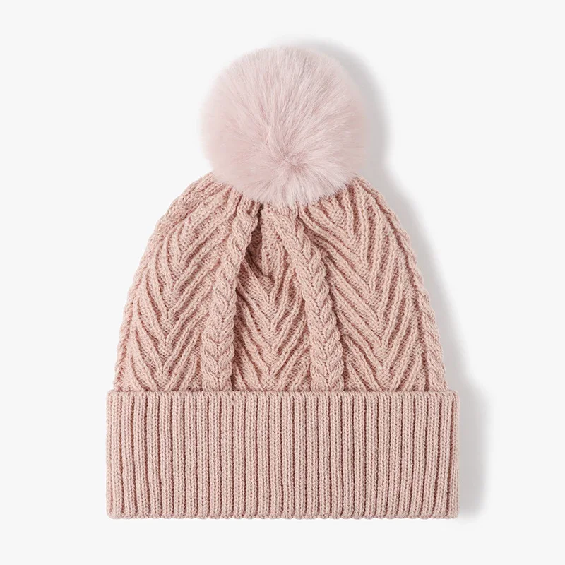 Dusty pink cable knit beanie with a folded ribbed cuff and pink pom