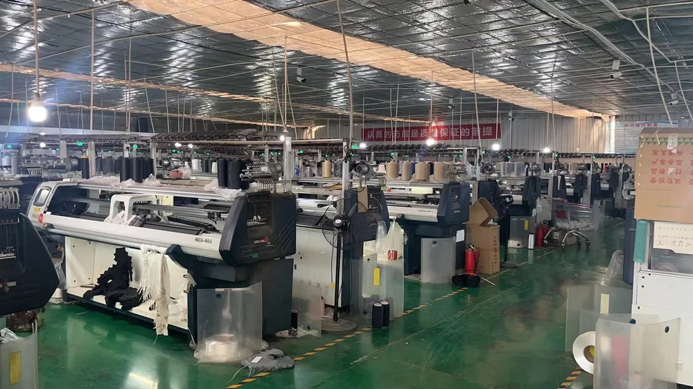 Industrial knitting machines on a textile workshop production floor