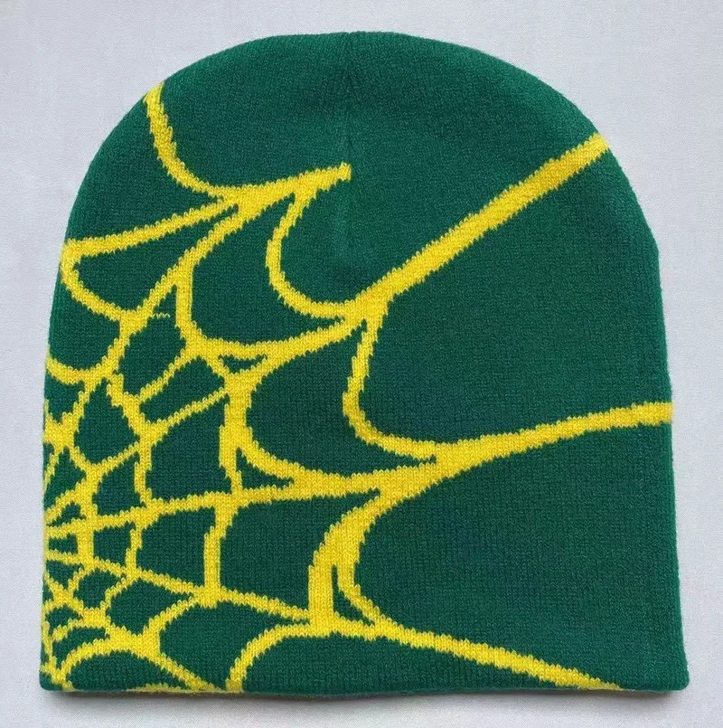 Green knit beanie with a yellow spiderweb motif