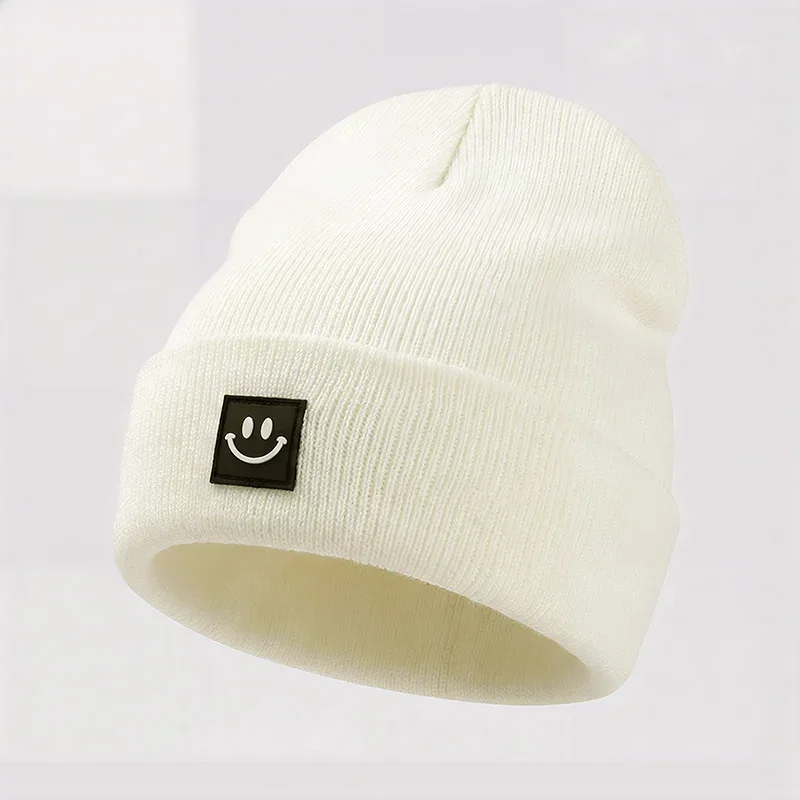 Ivory cuffed knit beanie with a black square smile label