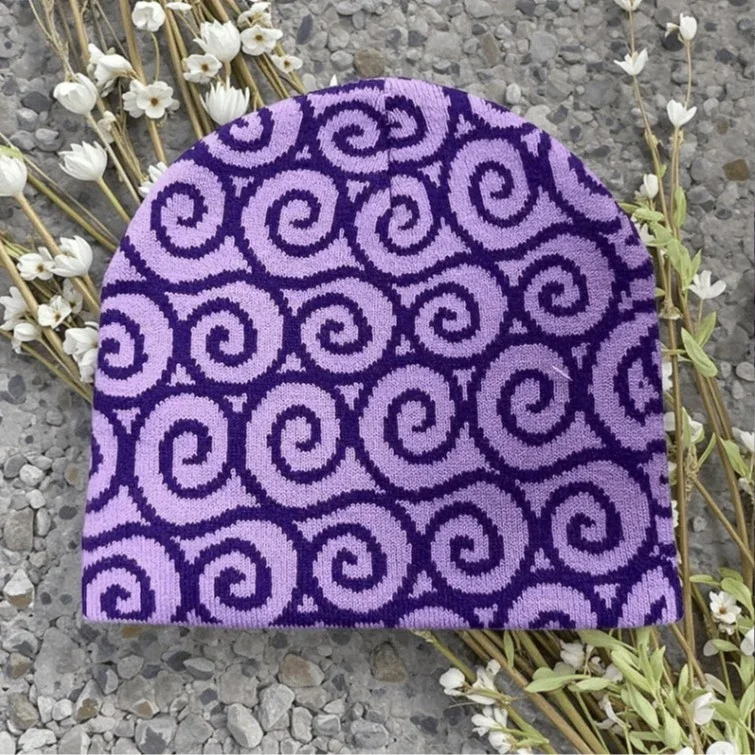 Lilac knit beanie with dark purple spiral motifs