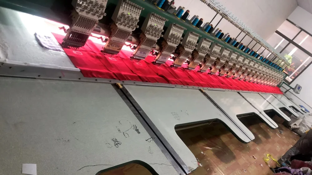 Multi-head industrial embroidery machine stitching red fabric