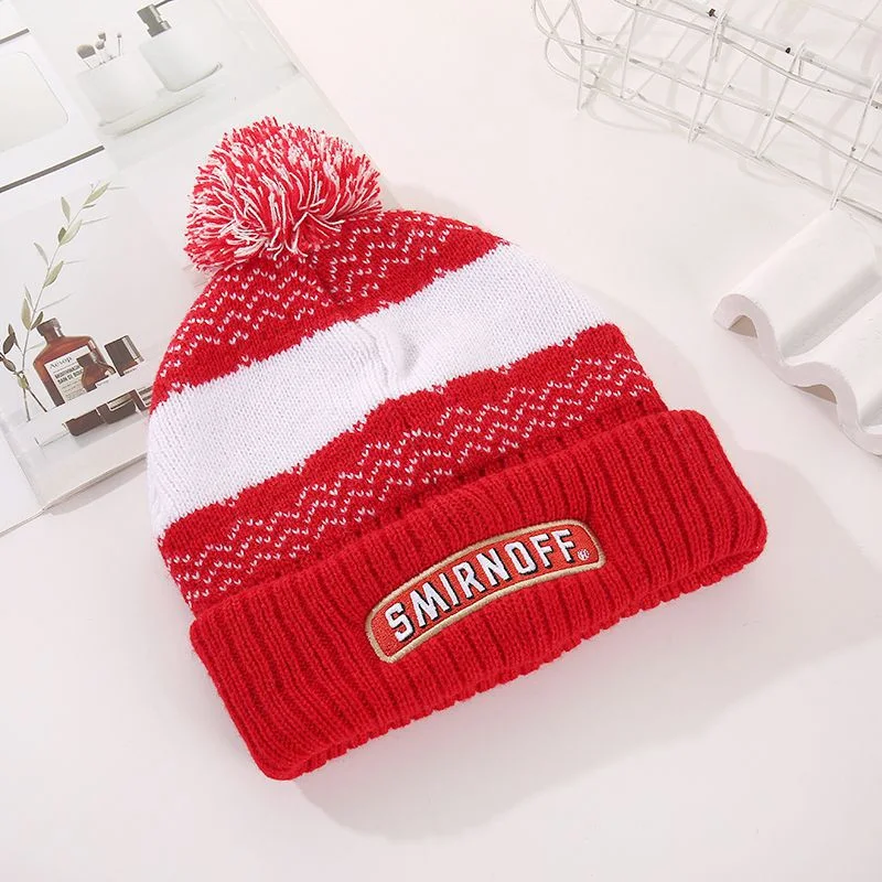 Red and white striped pom pom beanie with a rectangular smirnoff patch