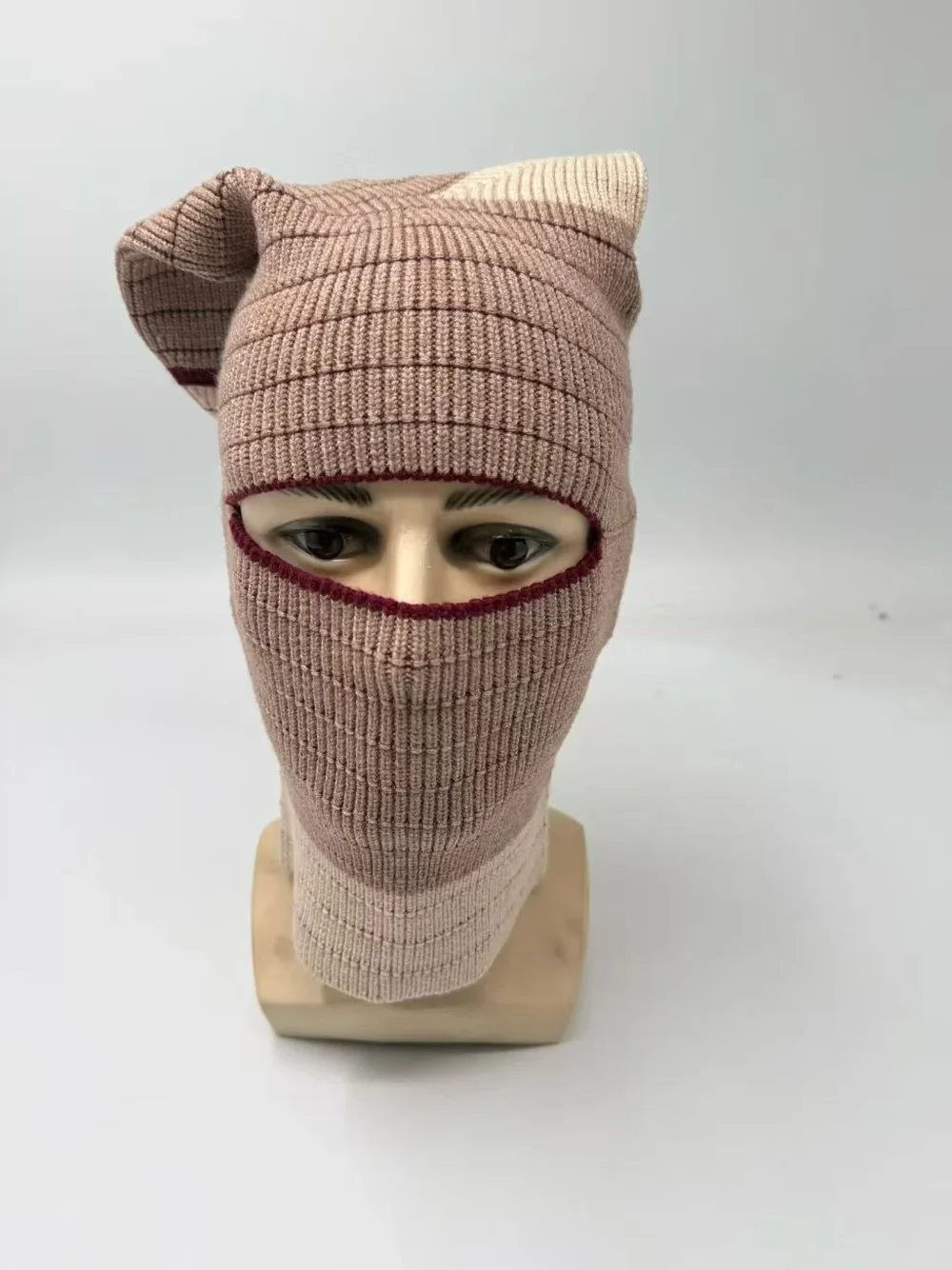 Taupe rib-knit balaclava with a horizontal eye opening and long neck section, front view.