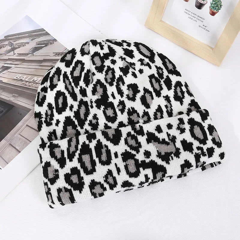 White knit beanie with a black leopard pattern