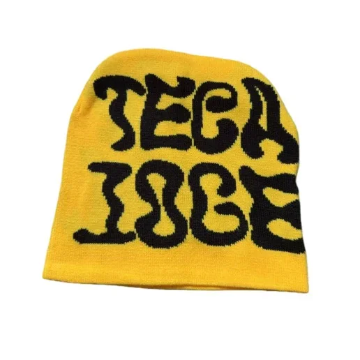 Yellow beanie with large black knitted lettering on the front.